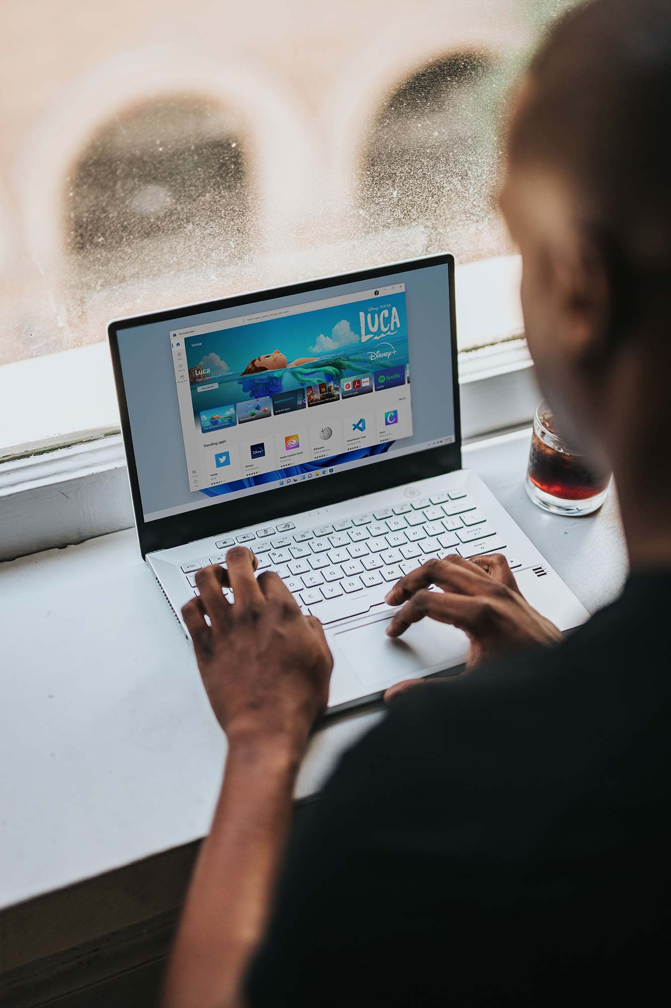 Person using a laptop with sci-fi posters in the background