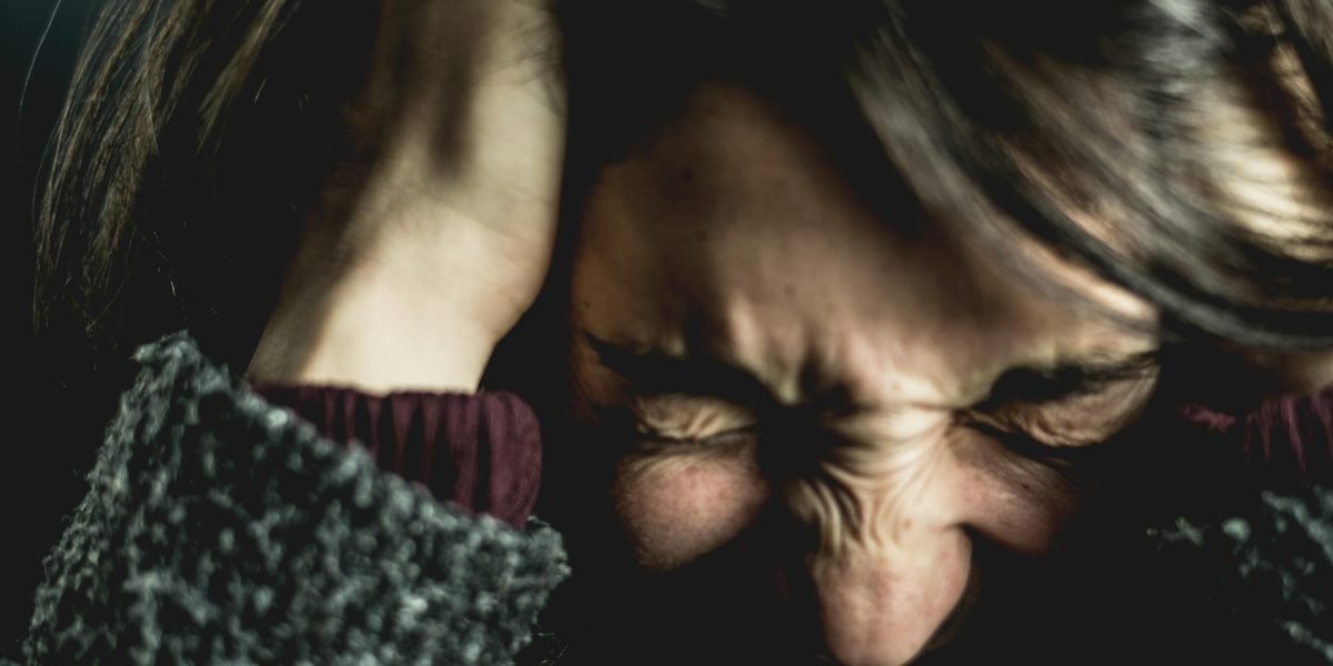 A person looking thoughtful or desperate, symbolizing humanity on the brink in a future setting.