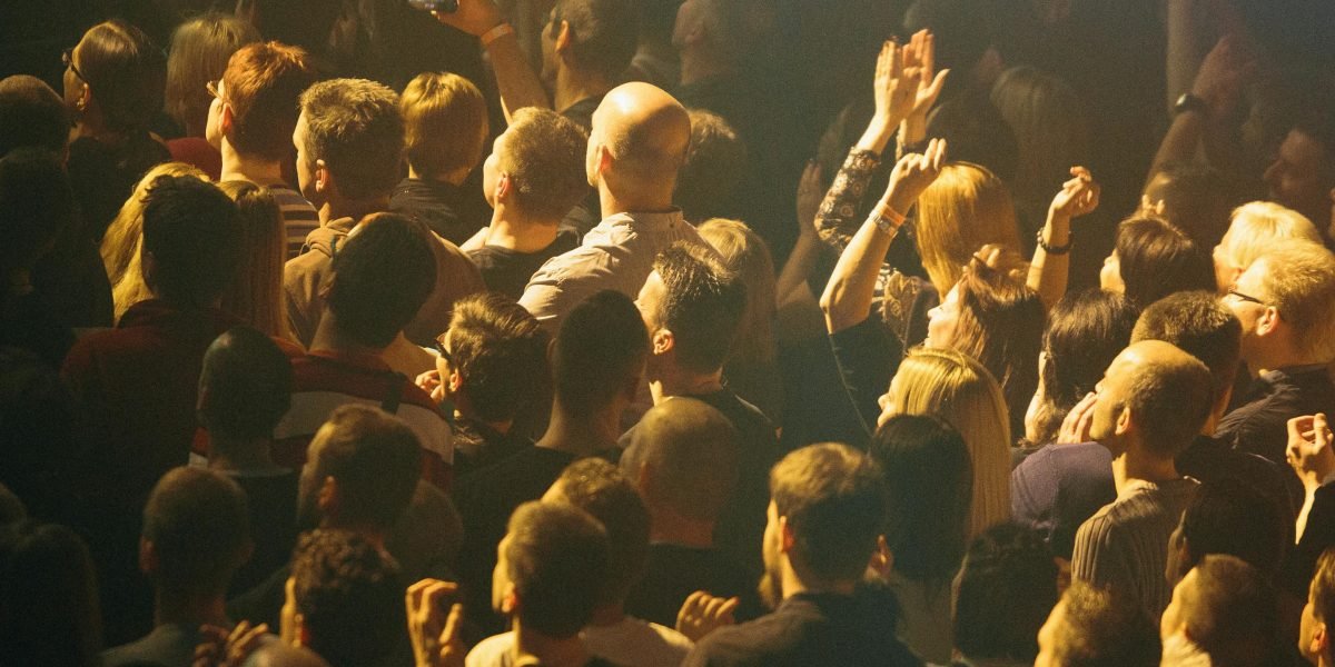 An audience captivated by a live performance, reflecting the impact of Hugh Jackman's musical roles.