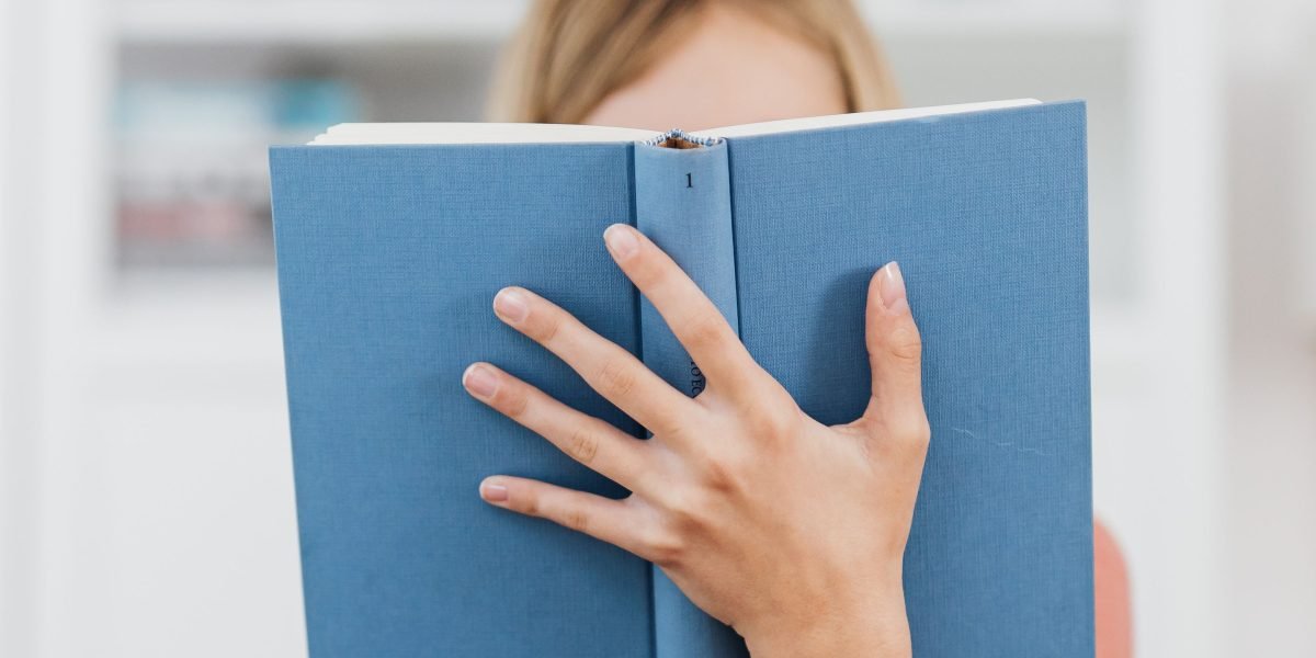 A person engrossed in reading, discovering a hidden literary gem.