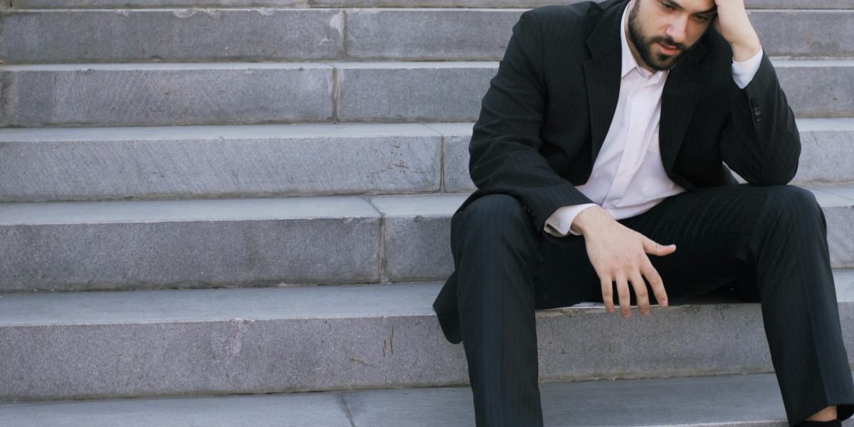 A person looking thoughtful or slightly disheartened, representing a moment of professional difficulty.