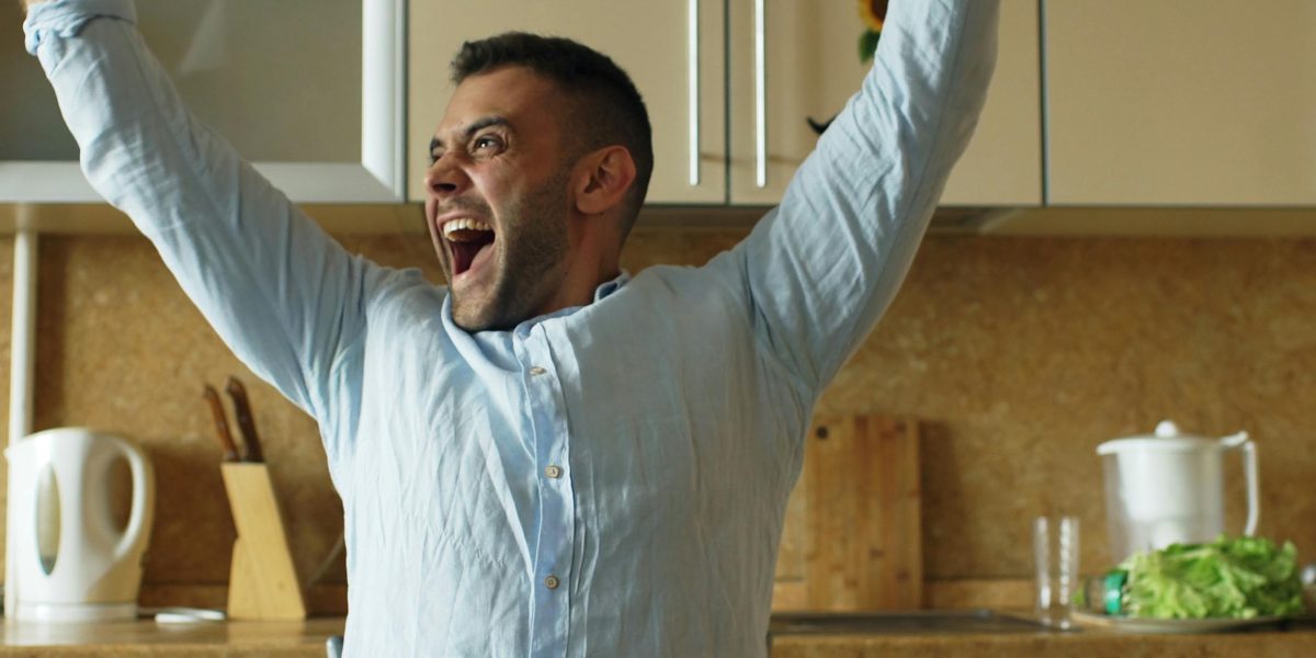 A person or small team celebrating a hard-won success or breakthrough moment after overcoming challenges.