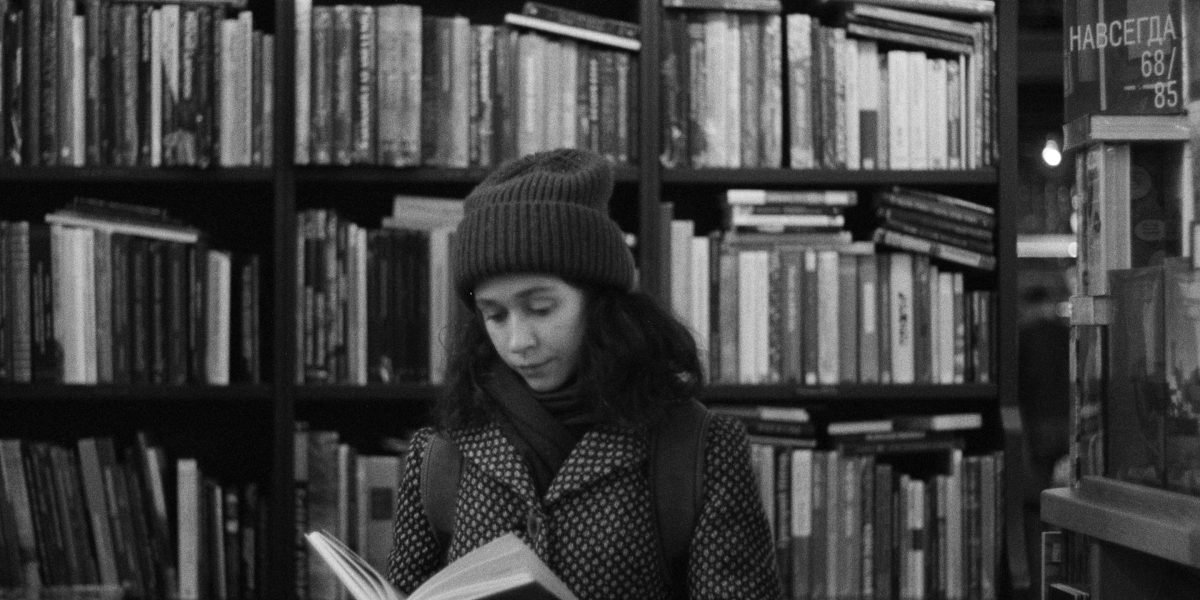 A person deeply engrossed in reading a book, suggesting a hidden gem discovered.